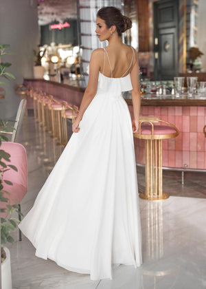 White chiffon wedding dress. Wedding dress with feathers.