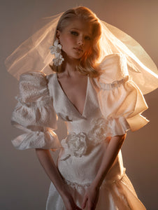 Unigue 90's inspired wedding dress with puffy sleeves. V-neck wedding dress online.