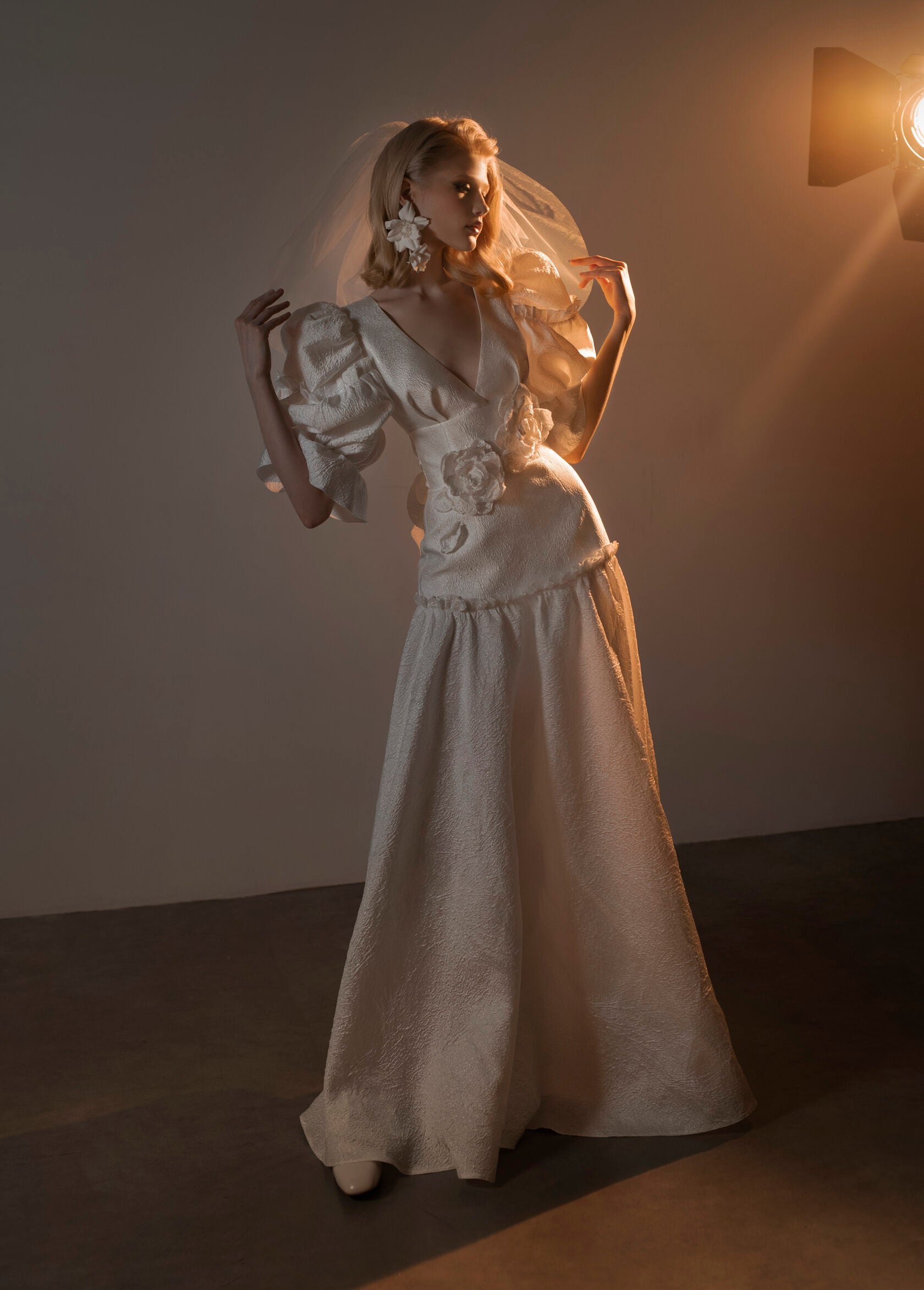 Unigue 90's inspired wedding dress with puffy sleeves.