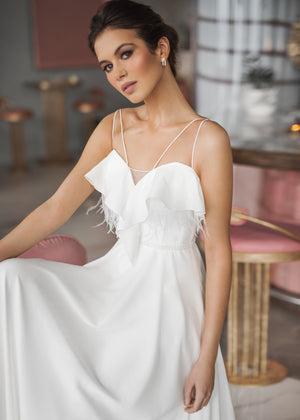 White chiffon wedding dress. Wedding dress with feathers.