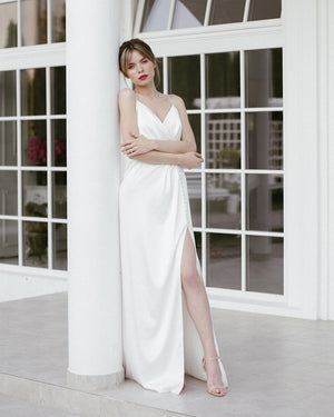 Simple wedding dress. White modern bridal gown. Wedding dress with a split.