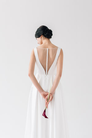 Simple white wedding dress online. Wedding dress with buttons. A-line minimal wedding dress.